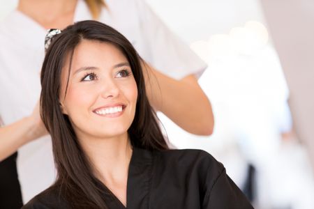 Beauty portrait of a woman at the hairdresser looking happy
