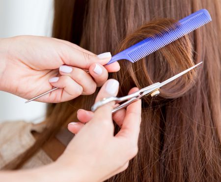 Cutting split ends of hair at the beauty salon