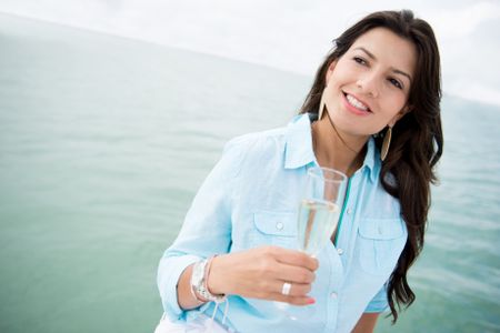 Woman in a boat drinking a glass of champagne
