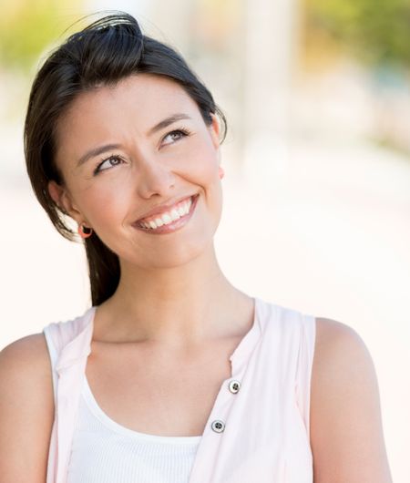 Portrait of a thoughtful woman looking up - outdoors