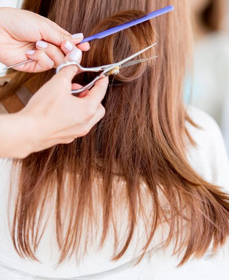 Getting a haircute on long hair at the beauty salon