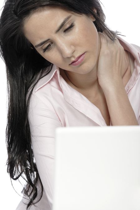 Beautiful young woman with neck pain at her office desk