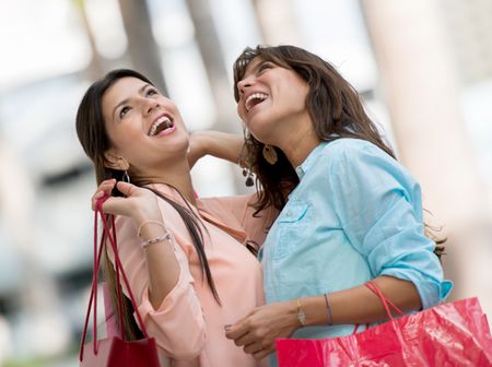 Happy women in a shopping spree carrying bags