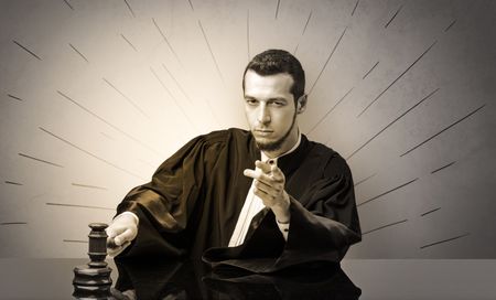 Young dashing judge in black gown making decision