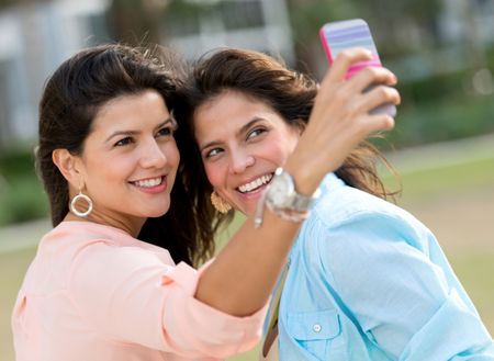 Friends taking a self portrait with a mobile phone