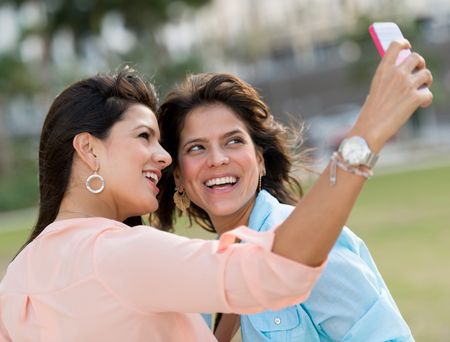 Girls taking a picture of themselves with the mobile phone