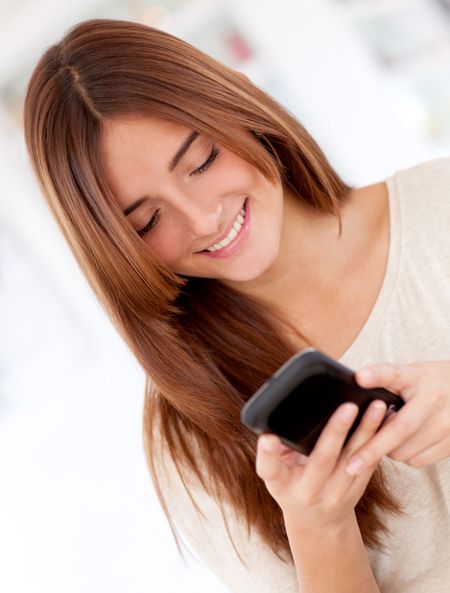 Portrait of a woman texting from her smart phone