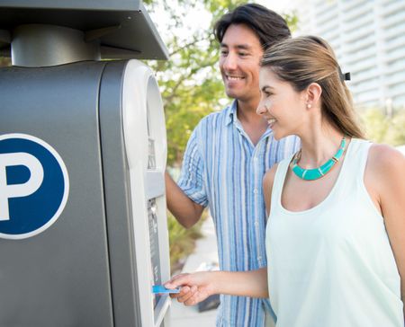 Couple paying for the parking lot with a credit card