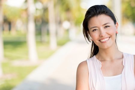 Portrait of a happy woman smiling at the park