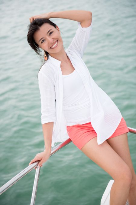 Beautiful summer woman in a yacht looking very happy