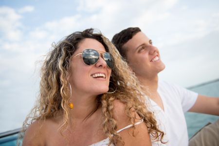 Happy mother and son sailing on a boat enjoying their holidays