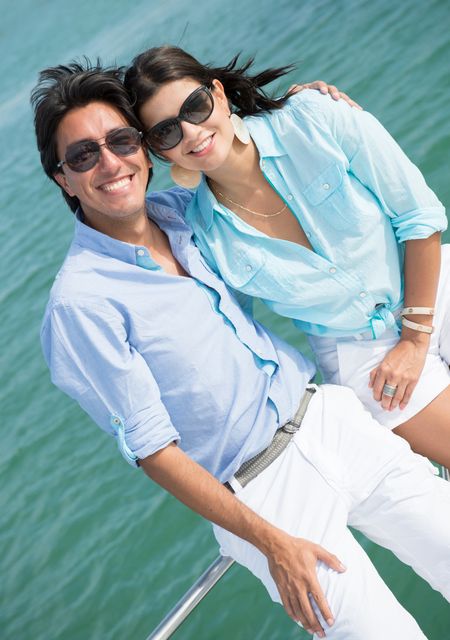 Couple enjoying the summer in a boat looking very happy