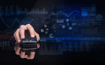 Hand using wireless mouse with financial concept on dark background