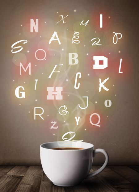 Coffee cup with colorful letters, close up