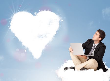 Handsome young man sitting on cloud with heart