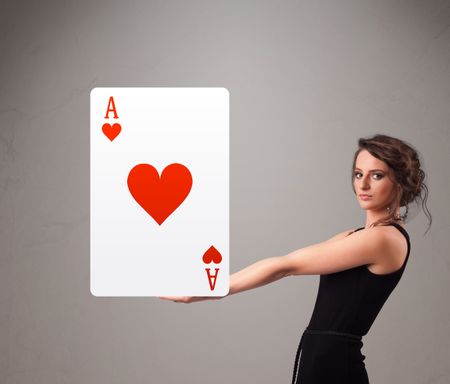 Beautifu young woman holding a red heart ace