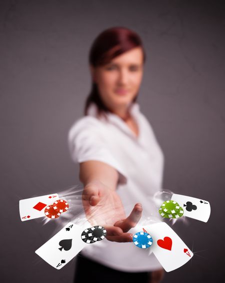 Pretty young woman playing with poker cards and chips