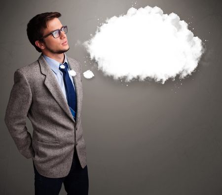 Good-looking young man thinking about cloud speech or thought bubble with copy space