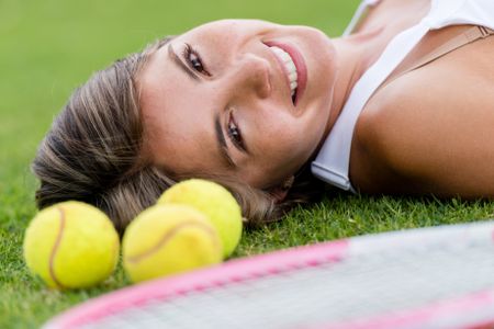 Portrait of a beautiful tennis player smiling