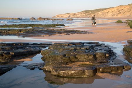 Woman with Dog on Monte Clerigo Beach, Portugal