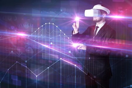 Businessman with virtual reality goggles organizing 3D graphs charts and financial variables