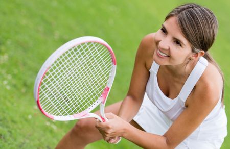 Woman playing tennis and looking very happy