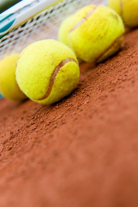 Set of tennis balls at the clay court