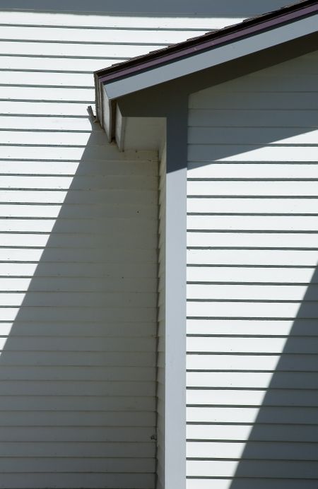 Corner of sloping church roof with afternoon shadows