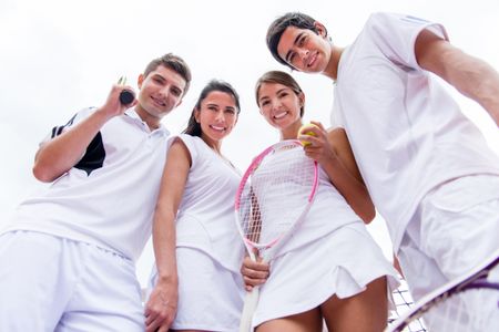 Group of tennis players looking happy and smiling