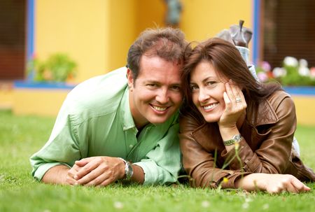 happy couple in their thirties smiling outdoors