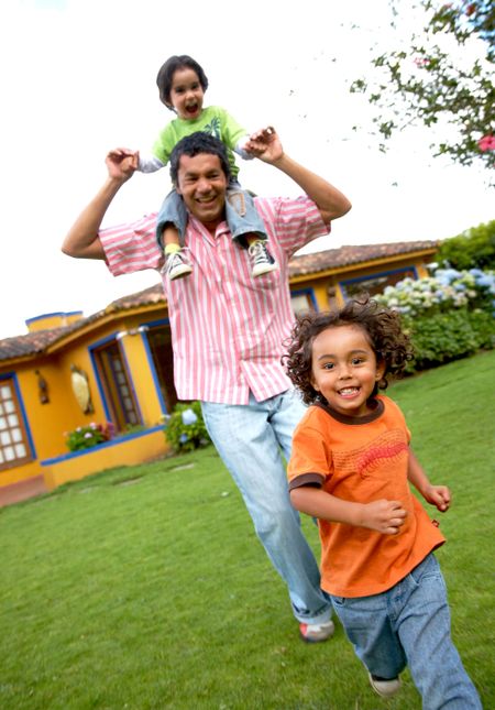 family lifestyle portrait of a dad with his sons having fun outdoors
