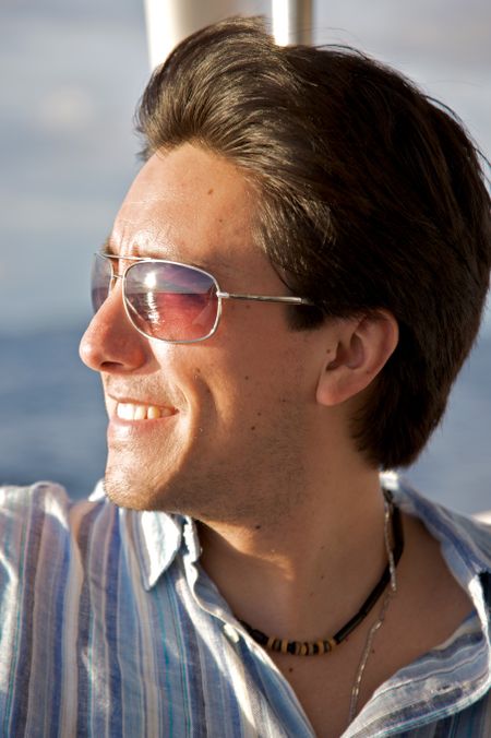 man portrait with sunglasses taken in a yatch
