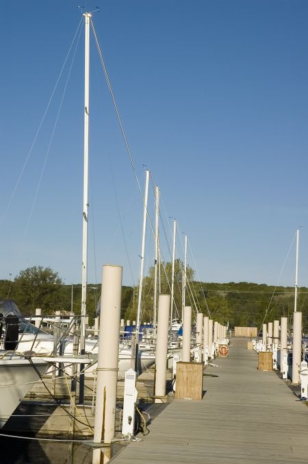 Long dock with sailboats in slips at marina
