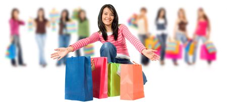 group of happy girls or women smiling and carrying shopping bags isolated over a white background