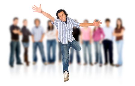 group of casual happy people smiling and standing isolated over a white background with a man jumping in front of everyone