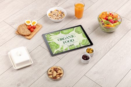 Fresh food on the table with a tablet PC.