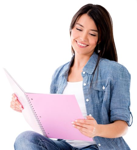 Female student reading a notebook - isolated over a white background