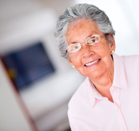Portrait of a happy senior woman smiling at home