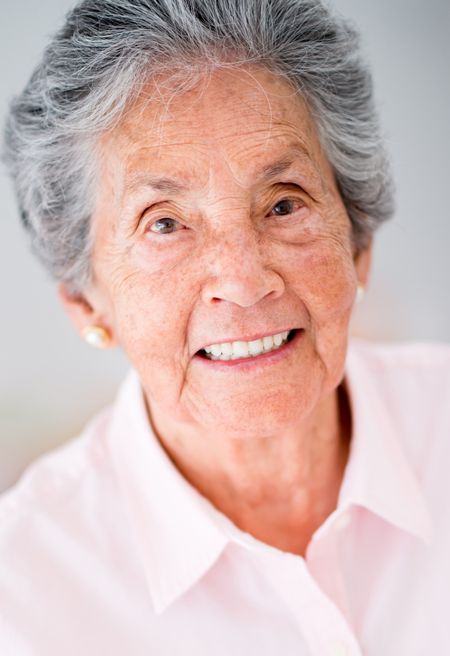 portrait-happy-elder-woman-smiling-138769274 Portrait of a happy elder woman smiling
