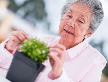Retired woman gardening outdoors enjoying some fresh air