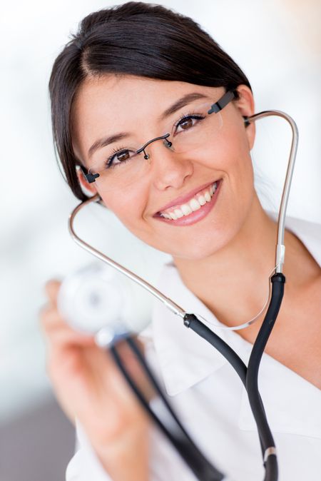 Happy female doctor holding a stethoscope and smiling