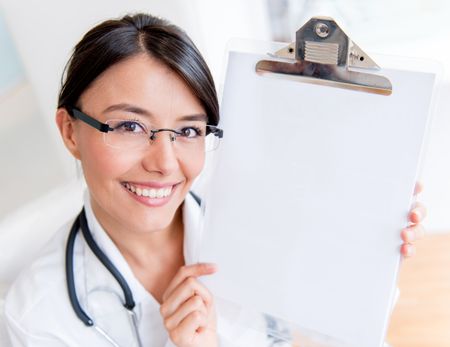 Female doctor showing prescription on a clipboard