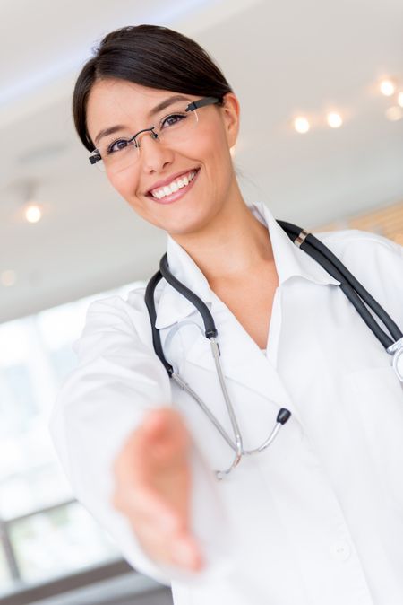 Welcoming doctor with hand extended to handshake