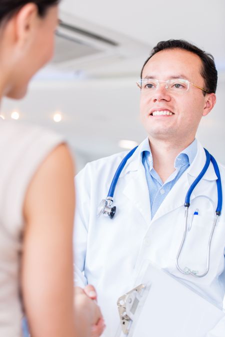 Doctor handshaking with a patient at the hospital