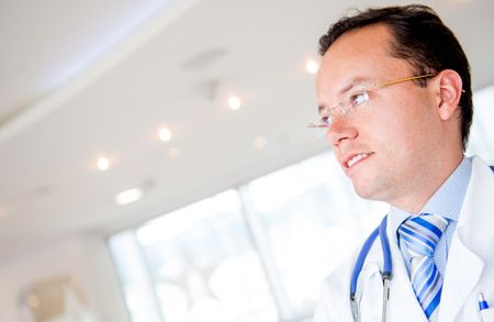 Thoughtful doctor at the hospital looking happy