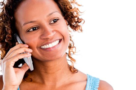 Happy black woman talking on the phone - isolated over a white background