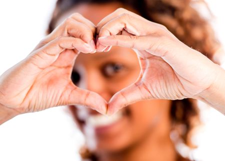 Romantic woman making a heart - isolated over a white background