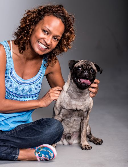 Casual woman with a cute dog looking happy
