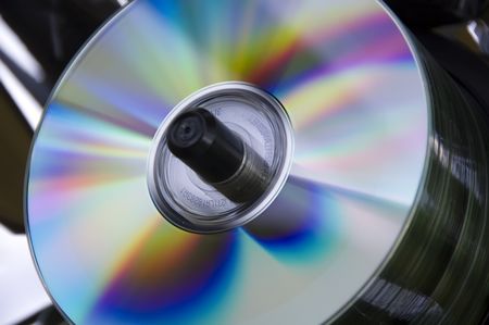 Stack of disks on spindle with multicolored reflections on top