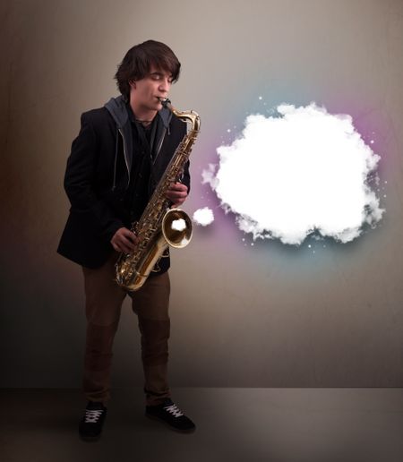 Handsome young man playing on saxophone with copy space in white cloud